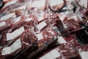 Fresh raw beef steaks vacuum packed for preservation in butcher shop, focused on meat processing, food supply chain, and retail industry, custom meat cutting near Peoria IL, meat cutting Peoria IL, meat processor Peoria IL, custom meat processor Peoria IL, USDA meat processing Peoria IL, beef processing Peoria IL, pork processing Peoria IL, custom butchering Peoria IL, meat packaging Peoria IL, meat fabrication Peoria IL, butcher services Peoria IL, meat processing near Peoria IL, livestock processing Peoria IL, custom meat packaging Peoria IL, restaurant meat supplier Peoria IL, wholesale meat processing Peoria IL, meat cutting services Peoria IL, meat processing Canton IL, USDA butcher Peoria IL, custom meat fabrication Peoria IL